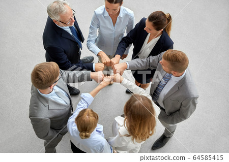 happy business people making fist bump happy business people making fist bump 64585415