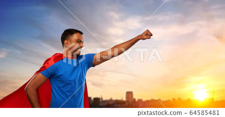 indian man in superhero cape makes winning gesture 64585481