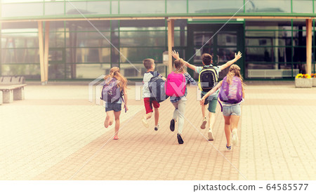 group of happy elementary school students running group of happy elementary school students running 64585577