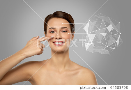 beautiful woman pointing finger to face skin 64585798