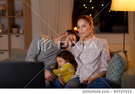 family watching tv together at night