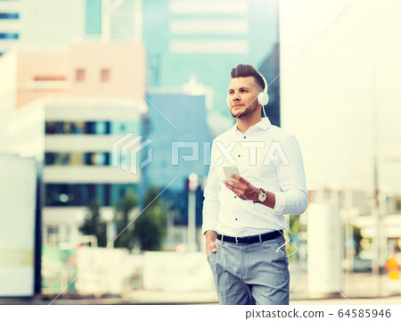 man with headphones and smartphone listening music 64585946