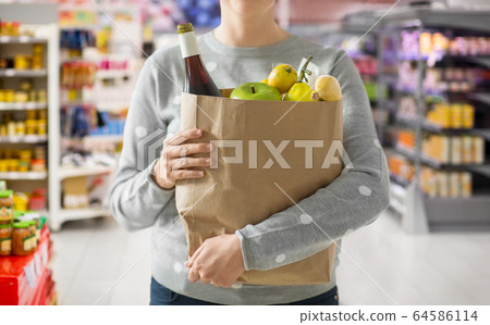 close up of woman with paper bag full of food close up of woman with paper bag full of food 64586114