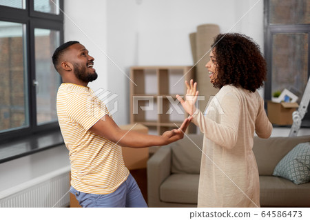 happy couple moving to new home and dancing happy couple moving to new home and dancing 64586473