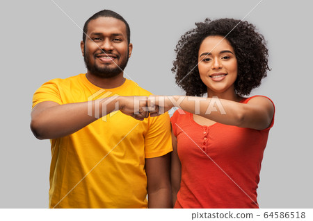 african american couple making fist bump gesture 64586518
