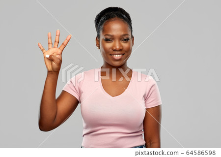 happy african american woman showing four fingers happy african american woman showing four fingers 64586598