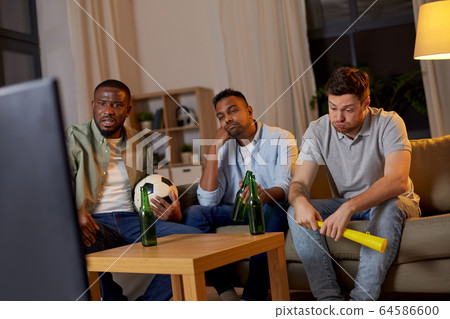 sad friends with beer watching soccer at home sad friends with beer watching soccer at home 64586600