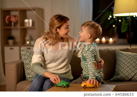 mother and son playing with toy cars at home mother and son playing with toy cars at home 64586633