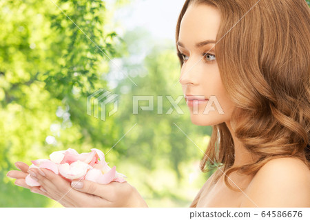 beautiful woman with rose flower petals beautiful woman with rose flower petals 64586676