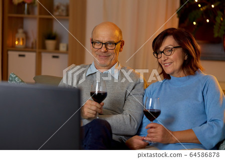 happy senior couple drink red wine and watch tv happy senior couple drink red wine and watch tv 64586878