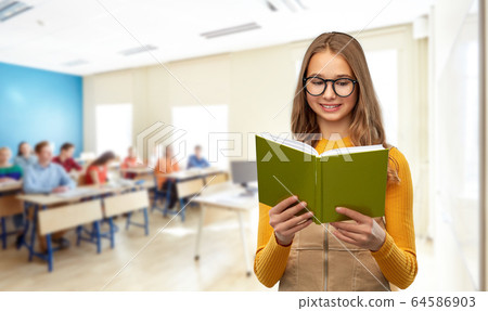 teenage student girl in glasses reading book 64586903