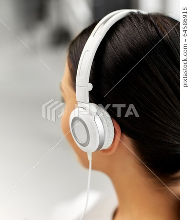 close up of woman in headphones listening to music close up of woman in headphones listening to music 64586918