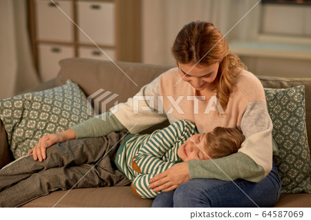 happy mother with sleeping little son at home 64587069