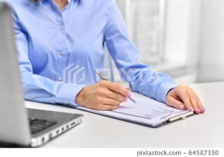 businesswoman with papers working at office businesswoman with papers working at office 64587330