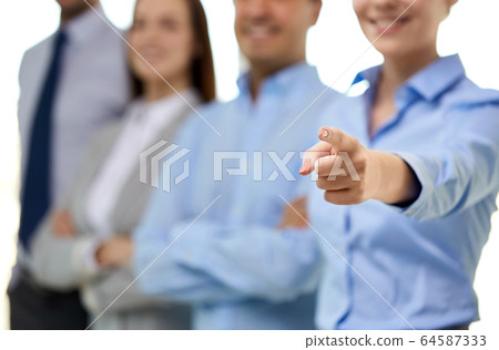 close up of smiling businesswoman pointing finger close up of smiling businesswoman pointing finger 64587333