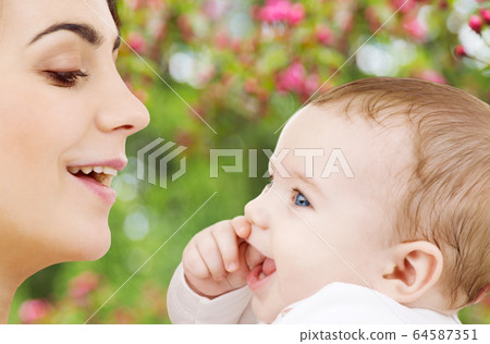 mother with baby over spring garden background 64587351