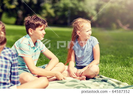 group of happy kids or friends outdoors 64587352