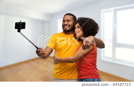 african american couple taking selfie by cellphone 64587723
