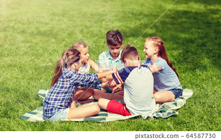 group of happy kids putting hands together group of happy kids putting hands together 64587730