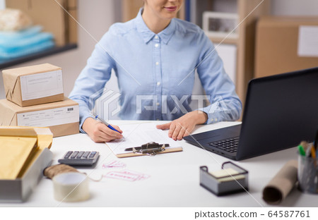 woman with laptop and clipboard at post office woman with laptop and clipboard at post office 64587761