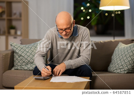 senior man with bills and calculator at home senior man with bills and calculator at home 64587851