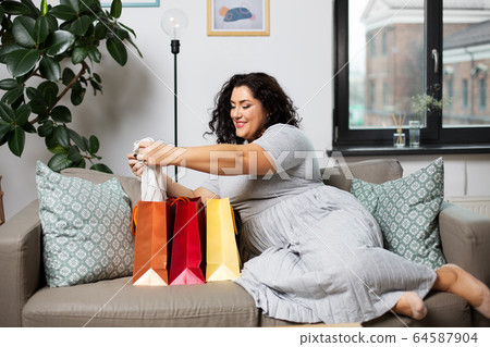 happy young woman with shopping bags at home happy young woman with shopping bags at home 64587904
