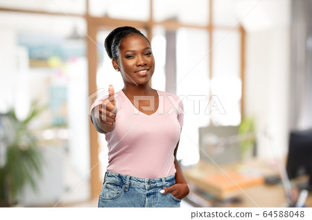 african woman showing thumbs up at office 64588048