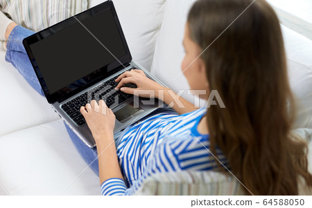 close up of teenage girl typing on laptop at home close up of teenage girl typing on laptop at home 64588050