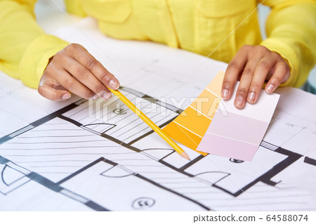 architect with blueprint and color palettes 64588074