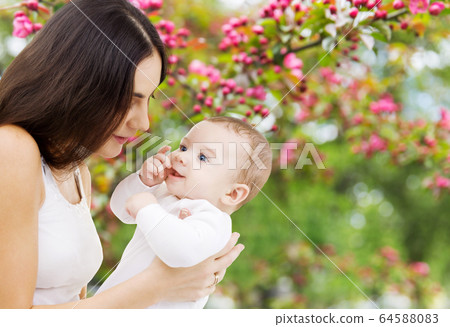 mother with baby over spring garden background 64588083