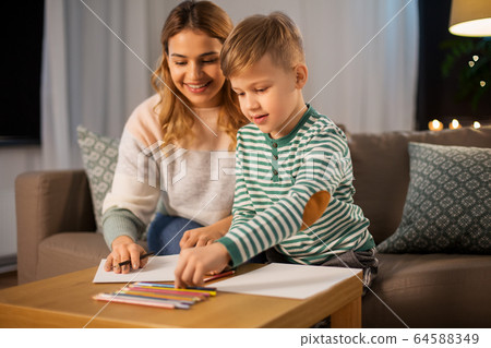 mother and son with pencils drawing at home 64588349