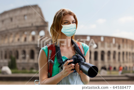 happy woman with backpack and camera outdoors happy woman with backpack and camera outdoors 64588477