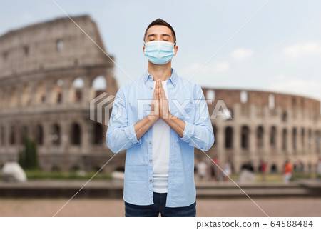 praying man wearing medical mask in italy praying man wearing medical mask in italy 64588484