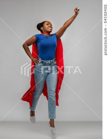 happy african american woman in red superhero cape happy african american woman in red superhero cape 64588488