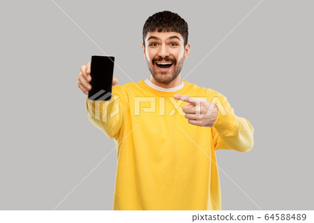 happy smiling young man showing smartphone happy smiling young man showing smartphone 64588489