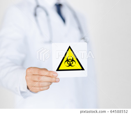 male doctor holding boihazard caution sign male doctor holding boihazard caution sign 64588552