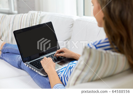 close up of teenage girl typing on laptop at home close up of teenage girl typing on laptop at home 64588556