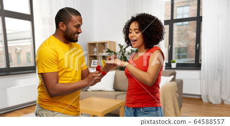 african american man giving woman engagement ring african american man giving woman engagement ring 64588557
