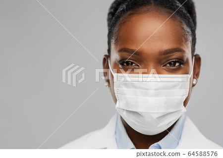 african american female doctor in facial mask african american female doctor in facial mask 64588576