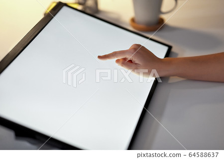 hand on led light tablet at night office 64588637