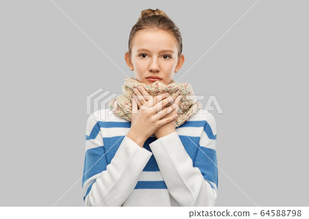 sick teenage girl in scarf over grey background 64588798