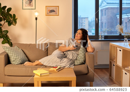 happy woman drinking red wine at home in evening happy woman drinking red wine at home in evening 64588923