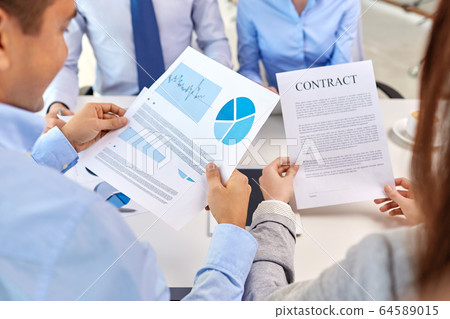 close up of business team with charts and contract 64589015
