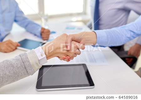 close up of businesspeople making handshake 64589016