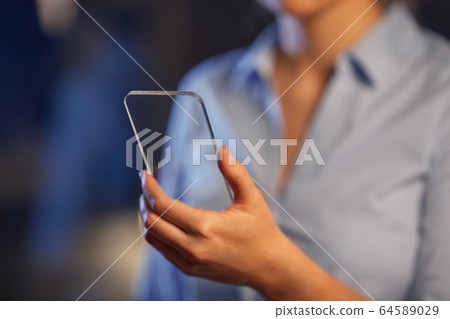 close up of hand with transparent smartphone close up of hand with transparent smartphone 64589029