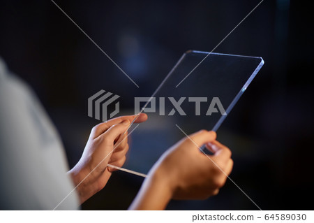 hands with transparent tablet pc computer 64589030