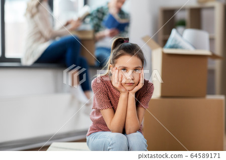 sad girl moving to new home with her family sad girl moving to new home with her family 64589171