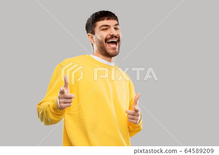 smiling young man showing thumbs up 64589209