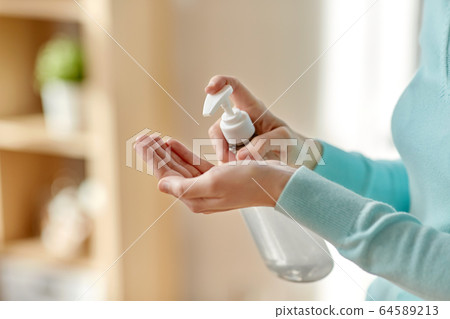 close up of woman applying hand sanitizer close up of woman applying hand sanitizer 64589213