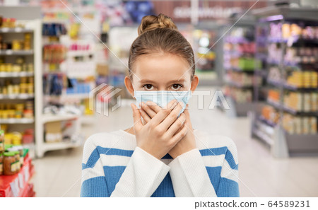 teenage girl in medical mask at supermarket 64589231